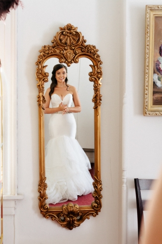 bride admires herself in the mirror-1
